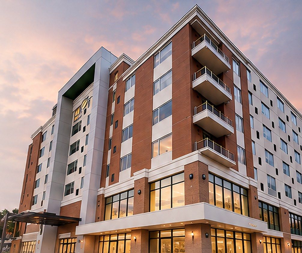 Multi-story brick and glass building at sunset